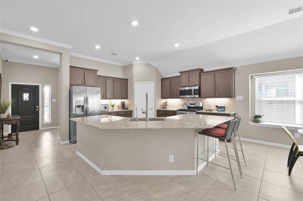 Looking back toward the front door and into the beautiful bright kitchen