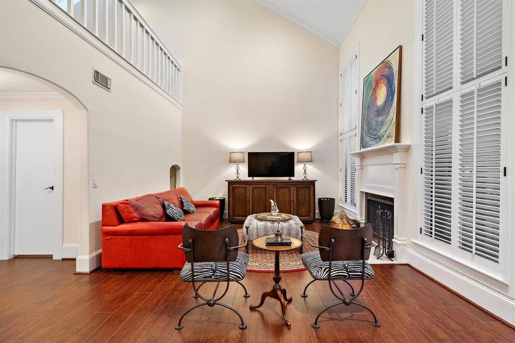 The open living area highlights a seamless flow into adjacent spaces, complemented by high ceilings and warm, natural tones.
