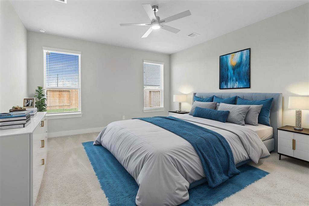 Come and unwind after a long day in this magnificent primary suite! This spacious room features plush carpet, warm paint, high ceilings with ceiling fan and large windows with privacy blinds.