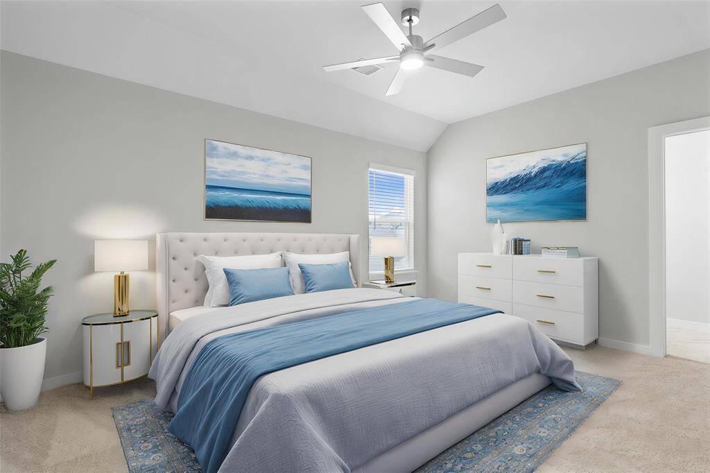 Secondary bedroom features plush carpet, custom paint, ceiling fan with lighting, ample closet space, large window with privacy blinds, and its own private access to a secondary bathroom.
