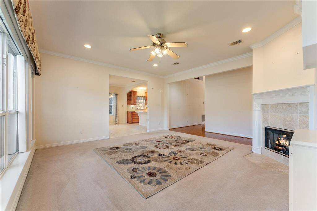 Living Room opening to Breakfast room and Kitchen. Gas Log Fireplace.