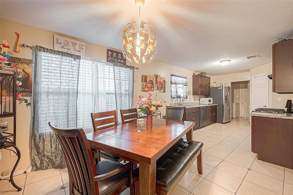 The dining room is bright and functional space, featuring tile flooring, easy to clean making it perfect for family meals.