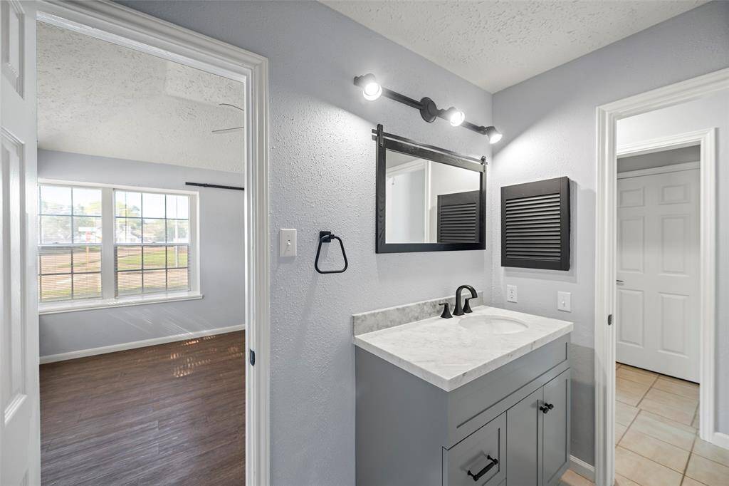 Secondary bath with extended upgraded vanity, storage closet to the left