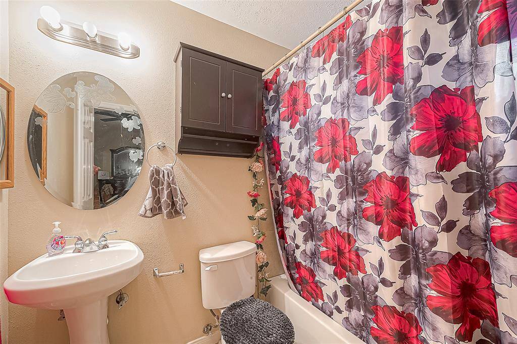 The primary bathroom is designed to provide a relaxing experience, complimenting the tranquility of the primary bedroom.