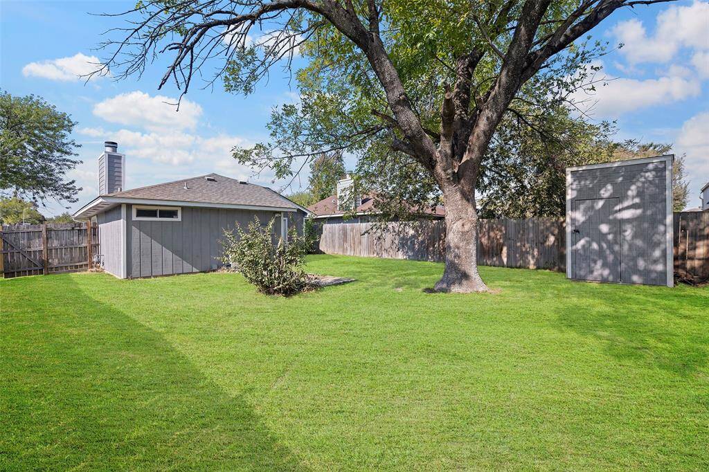 Backyard with mature tree and storage shed