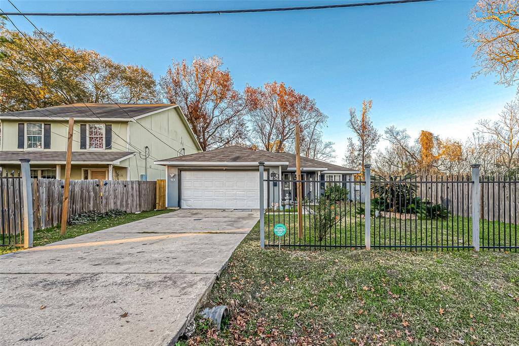 Not only does this home feature a beautiful landscaped front yard but also features a sturdy iron fence for added charm and security.