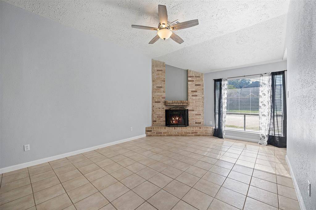 Vaulted ceiling, wood burning fireplace and easy to maintain tile floor