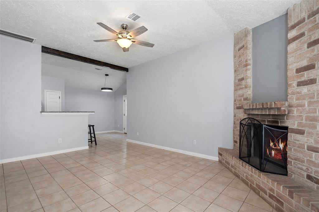 High ceilings, fresh paint, updated lighting and gorgeous wood burning fireplace