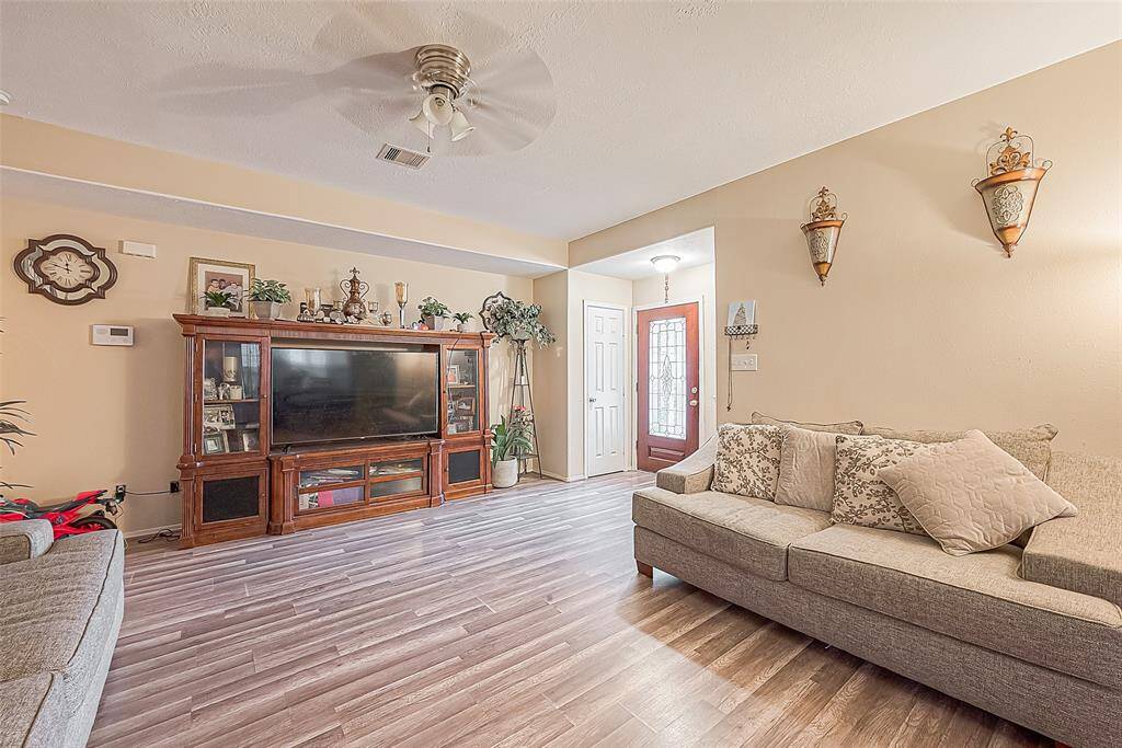 This living area features  beautifully updated flooring that ties with the space.