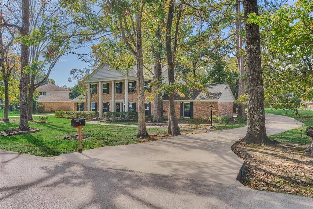 Charming Curb Appeal and winding driveway through mature trees