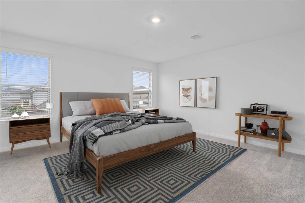 Come and unwind after a long day in this magnificent primary suite! This spacious room features plush carpet, warm paint, high ceilings and large windows with privacy blinds.