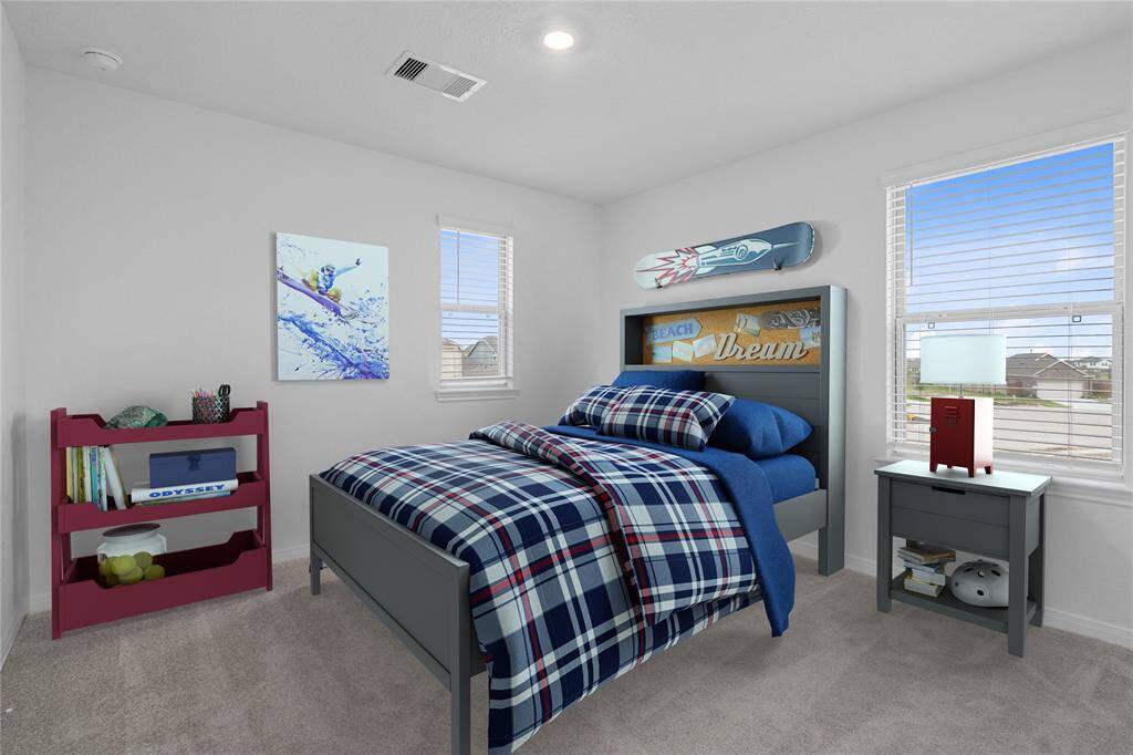 Secondary bedroom features plush carpet, neutral paint, lighting, large window with privacy blinds and a walk-in closet.