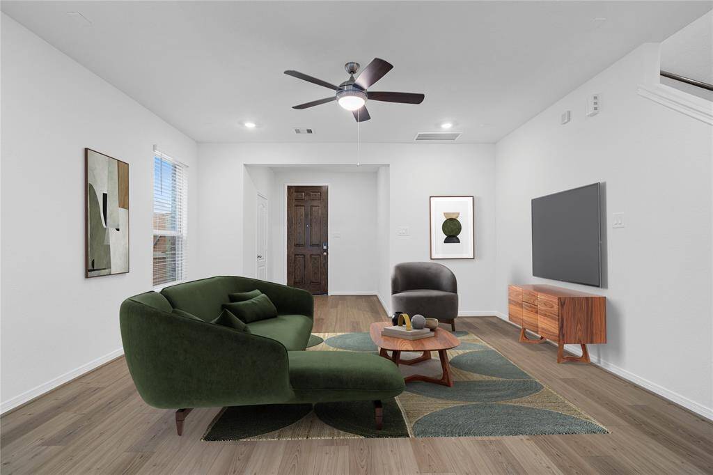 This light and bright spacious family room is the perfect layout for entertaining or just relaxing. Whether it's simply a night in or entertaining family and friends, this home has ample open space for everyone to enjoy! Featuring vinyl plank flooring, large windows with blinds, high ceilings, recessed lighting, ceiling fan, and wonderful access to your gorgeous kitchen.