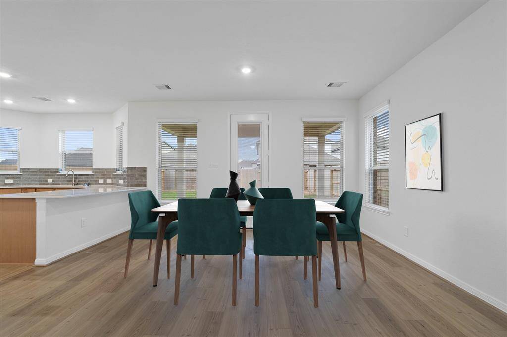 Make memories gathered around the table with your family and friends! The dining area features high ceilings, large windows with blinds, and easy access to your kitchen and family room