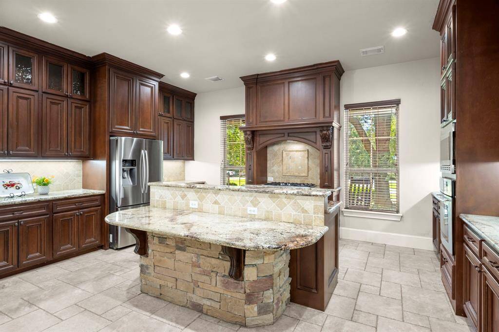 Under-cabinet and upper-cabinet lighting brighten this kitchen.