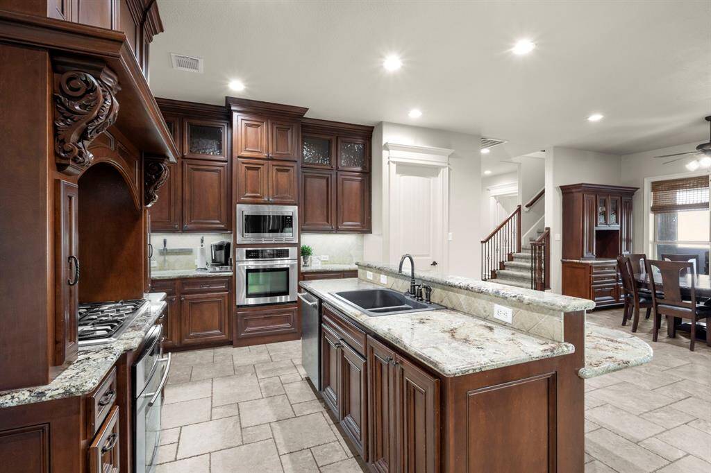 Under the corbels, you'll find pull out spice storage. There are also pull out drawers in many of the bottom cabinets for functional accessibility to pots/pans, and a trash cabinet drawer next to the sink.