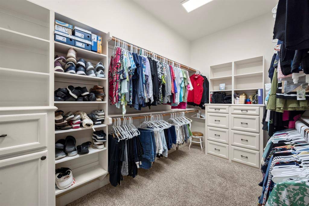 Primary closet #2 - Built-in dresser, shelves, and clothes hamper cabinet.