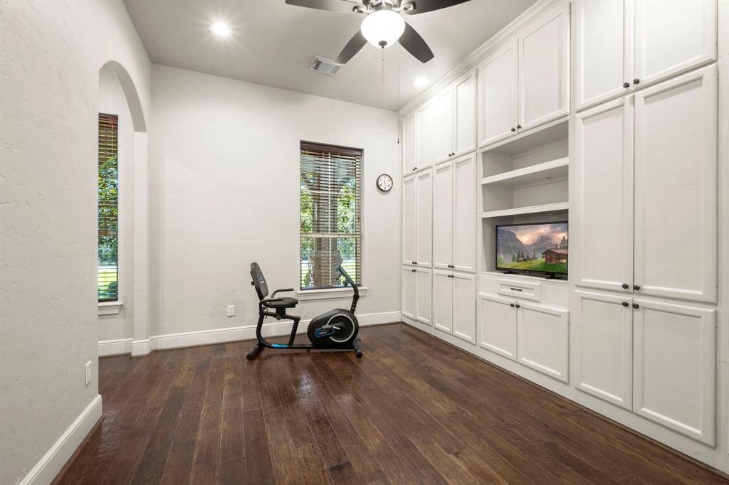 Flex space may be your home office, craft room, workout space, or play room. The built-in cabinets provide excellent storage and the archway to the left is a private computer nook.