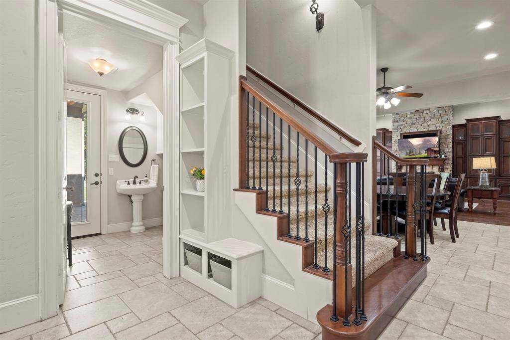 Drop zone near the kitchen, along with the powder bath that exits to the pool area.