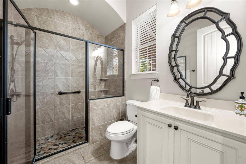 Bedroom 2 Ensuite Bath - Walk in shower with shower head and hand-held sprayer, barrel ceiling, window for natural light, grab bars, elongated toilet and widened doorway.