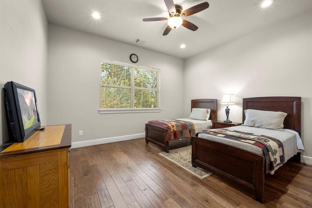 Bedroom 3 - This room sits upstairs with wood flooring, ceiling fan, recess lighting, large closet and a view over the driveway.