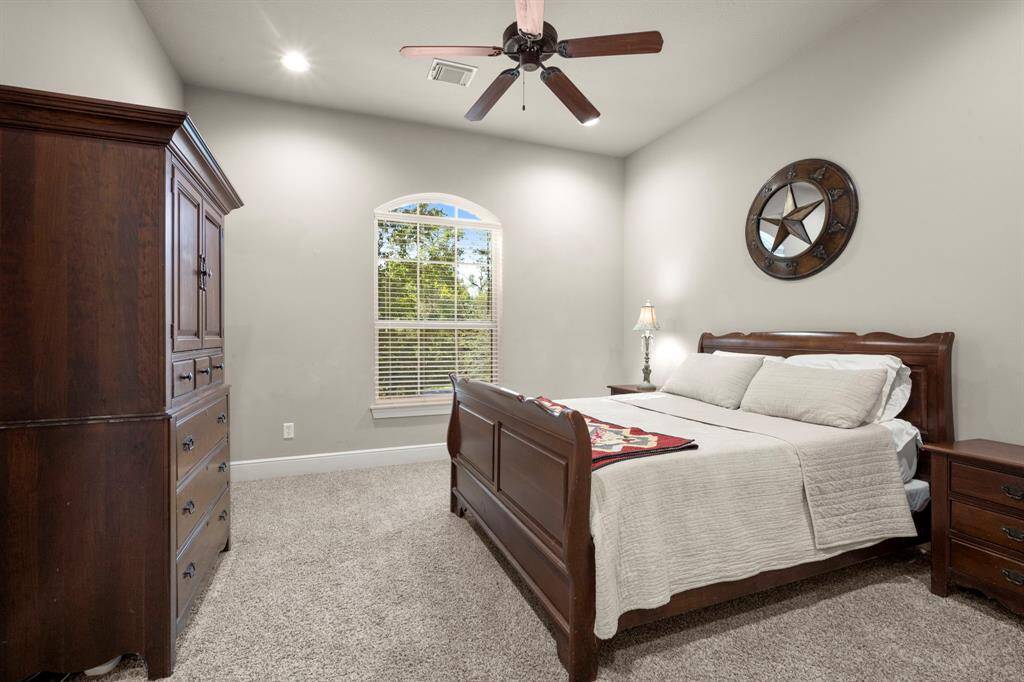Bedroom 4 - This bedroom lies upstairs with plush carpet, recess lighting, ceiling fan, large walk-in closet, direct access to the upstairs bath and a view over the front lawn.