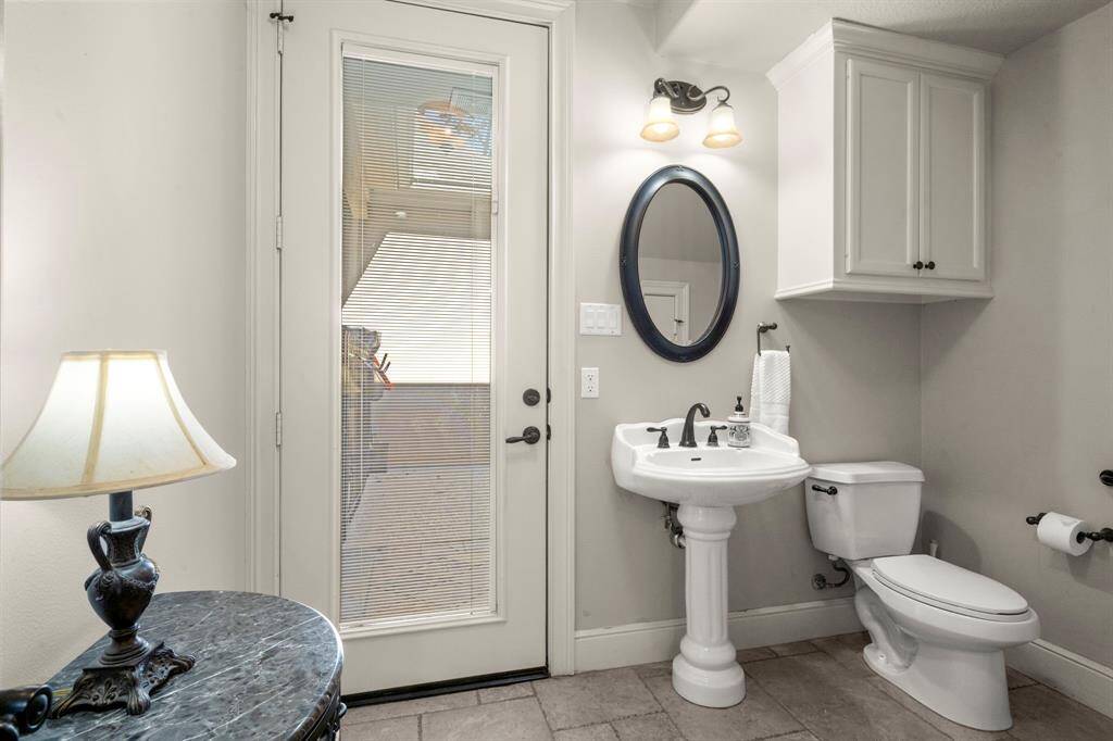 Powder room offers and exit to the pool area. There is also a large storage closet in this room not show in in the photo - perfect location for pool towels, toys and sunscreen. Full light glass door with inset blinds.