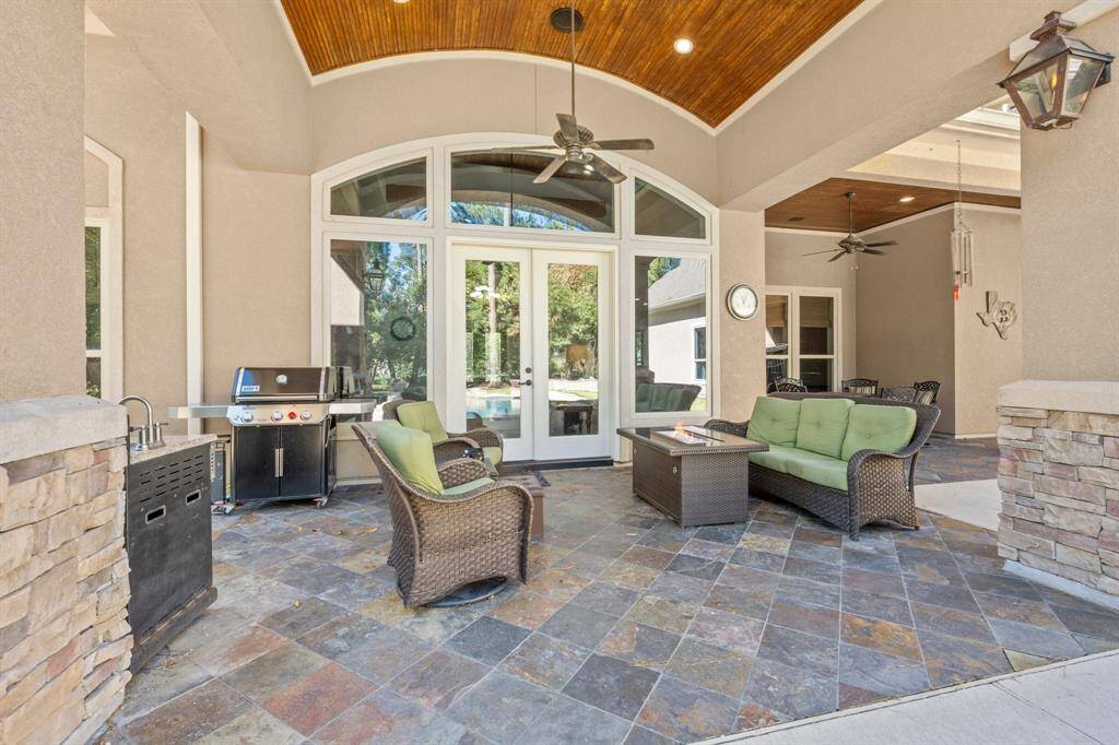 Barrel wood plank ceiling, slate floors, wall of windows, gas powered wall sconces, ceiling speakers, recess lighting.