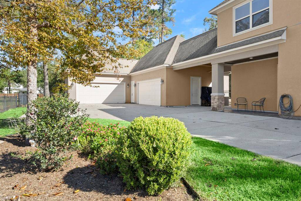 Four car garage, extra parking, and an additional workshop are bonus features that are hard to find! Notice the seating area overlooking the driveway.