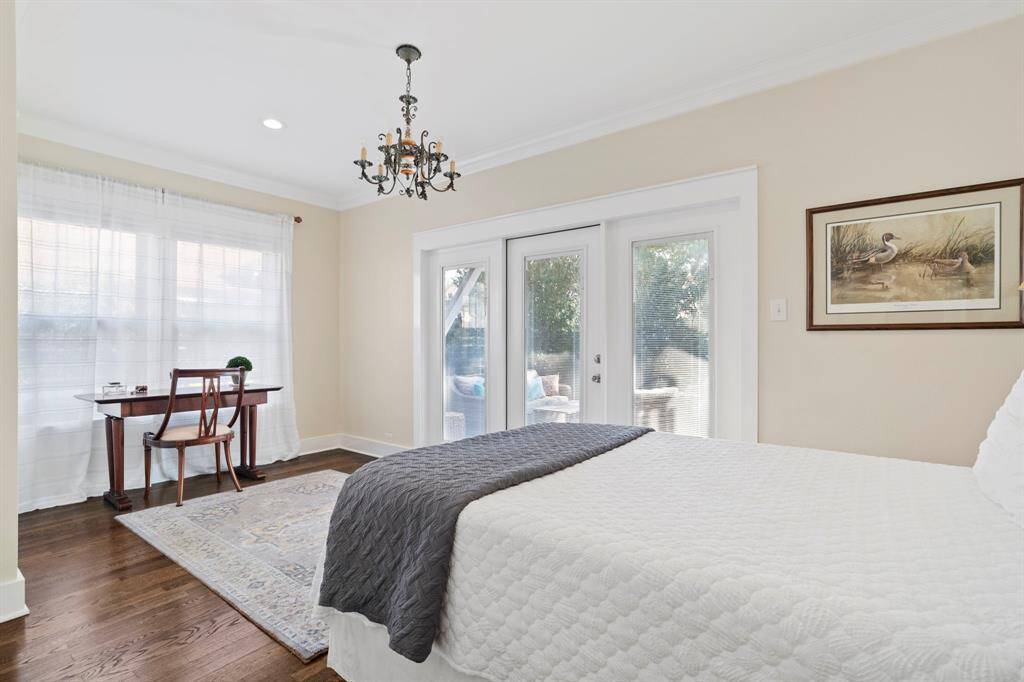 Spacious primary bedroom with en suite bathroom and French door that opens to the back yard oasis.