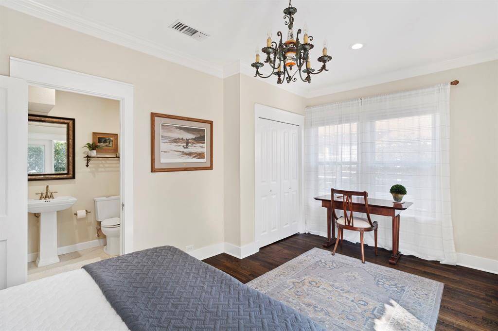 Another view of the primary suite. New recessed LED lighting and fun, eclectic chandelier is another example and combining old and new design features.