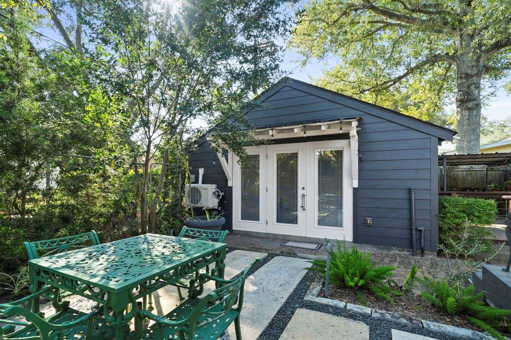 Detached garage and storage/workshop has been converted into a studio/garden room with kitchen efficiency unit and mini split AC/heating.