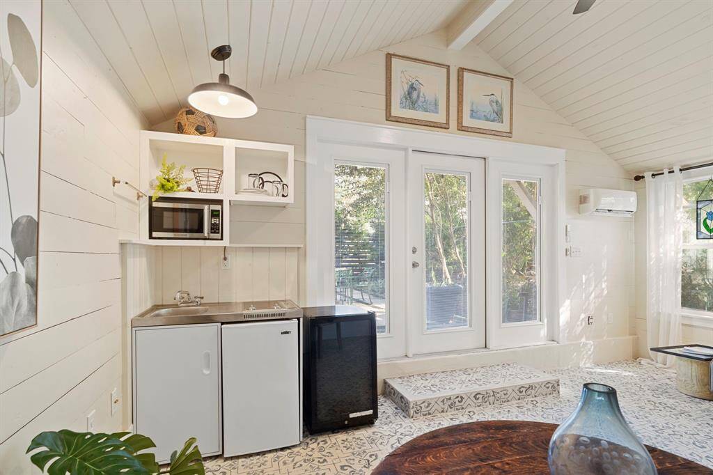Kitchenette in the studio includes a stainless steel sink, microwave, 2-burner electric cooktop, and mini fridge.