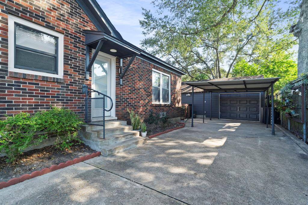 Side entrance to the kitchen. Carport & garage w/220 plug for electric car charging.