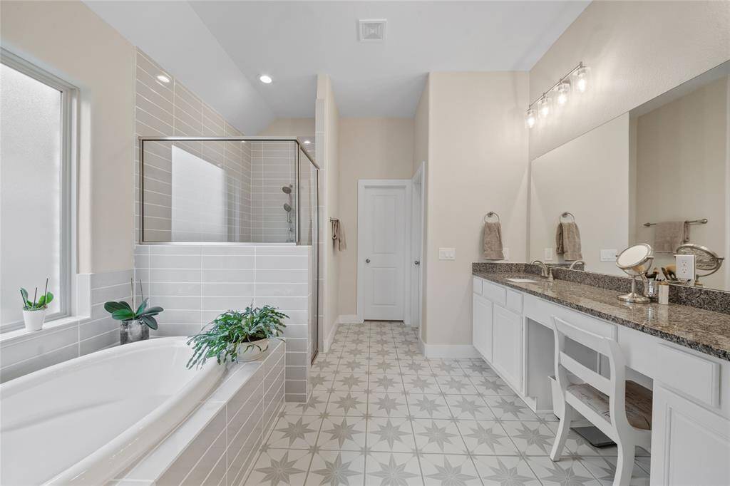 Primary bathroom, large window allows for great natural light, and large mirrored wall.