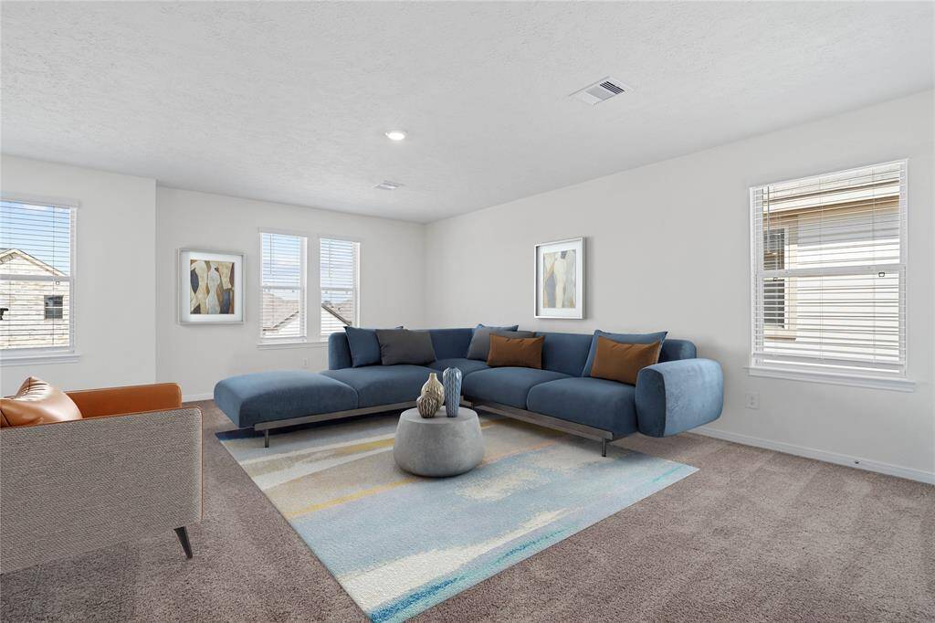 Come upstairs and enjoy a day of leisure in this fabulous game room! This is the perfect hangout spot or adult game room, this space features plush carpet, high vaulted ceiling, recessed lighting, custom paint, and plenty of windows with blinds!
