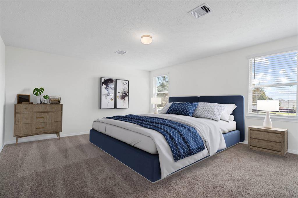 Come and unwind after a long day in this magnificent primary suite! This spacious room features plush carpet, warm paint, high ceilings, and large windows with privacy blinds!