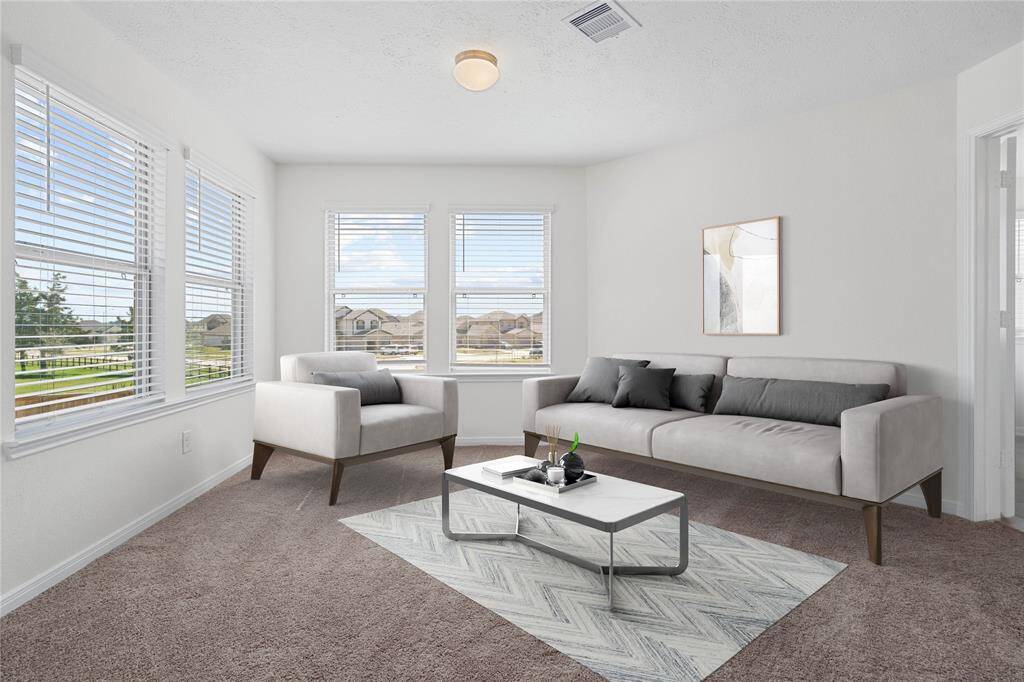 This sitting room joined with the primary bedroom is perfect for sitting with a book, an office, workout room, or even a nursery. The possibilities are endless and makes the primary suite an oasis of privacy.