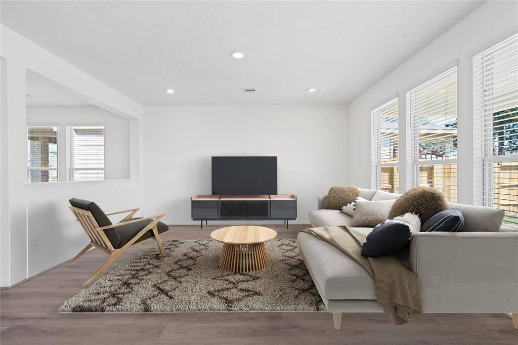 Gather the family and guests together in your lovely family room! Featuring high ceilings, recessed lighting, custom paint, gorgeous vinyl plank flooring and large windows with blinds that provide plenty of natural lighting throughout the day.