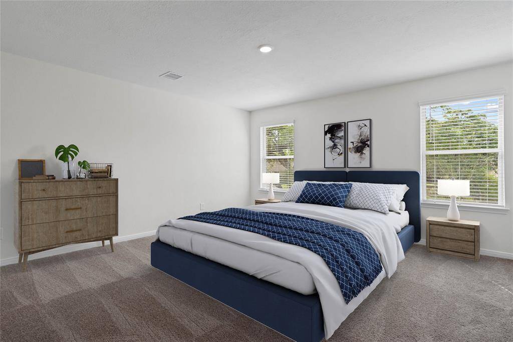 Come and unwind after a long day in this magnificent primary suite! This spacious room features plush carpet, warm paint, high ceilings, recessed lighting, and large windows with privacy blinds.