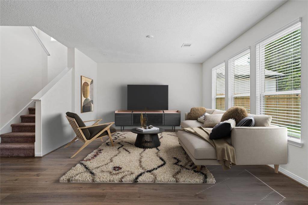This light and bright spacious family room is the perfect layout for entertaining or just relaxing. Whether it's simply a night in or entertaining family and friends, this home has ample open space for everyone to enjoy! Featuring vinyl plank flooring, large windows with blinds, high ceilings, recessed lighting, and wonderful access to your gorgeous kitchen.