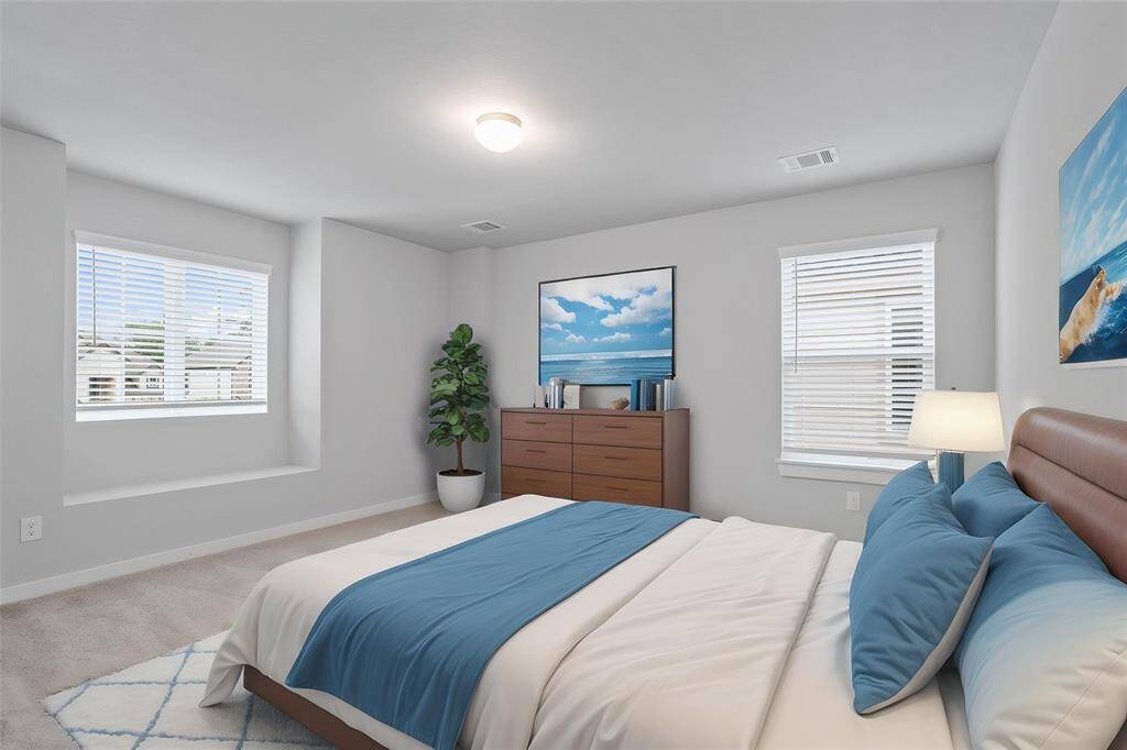 Secondary bedroom features plush carpet, custom paint, high ceiling, lighting, ample closet space, and large windows with privacy blinds.