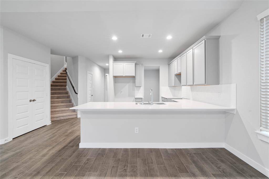 Additional view of the kitchen, pantry, and staircase leading to the second floor!