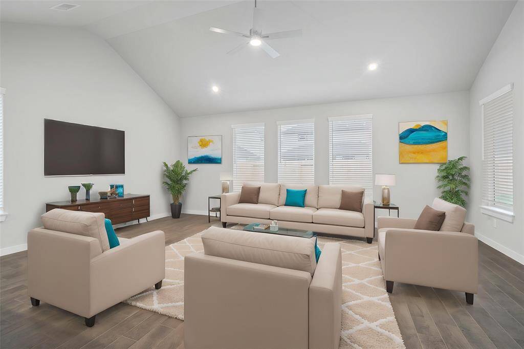 Gather the family and guests together in your lovely family room! Featuring high ceilings with ceiling fan, recessed lighting, custom paint, gorgeous wood look tile floors and large windows that provides plenty of natural lighting throughout the day.