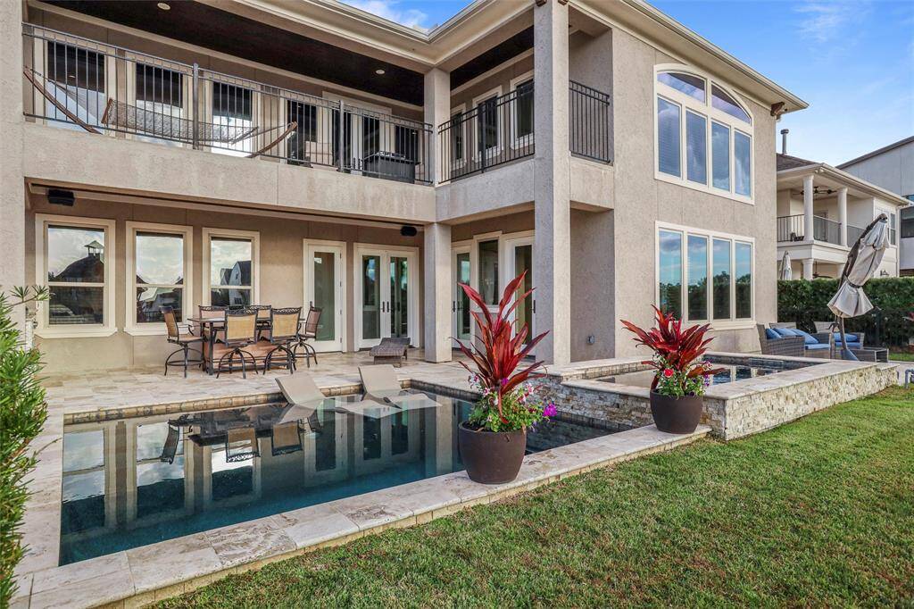 Discover tranquility in this backyard oasis featuring a 9-foot deep pool and a spacious hot tub perfect for entertaining.