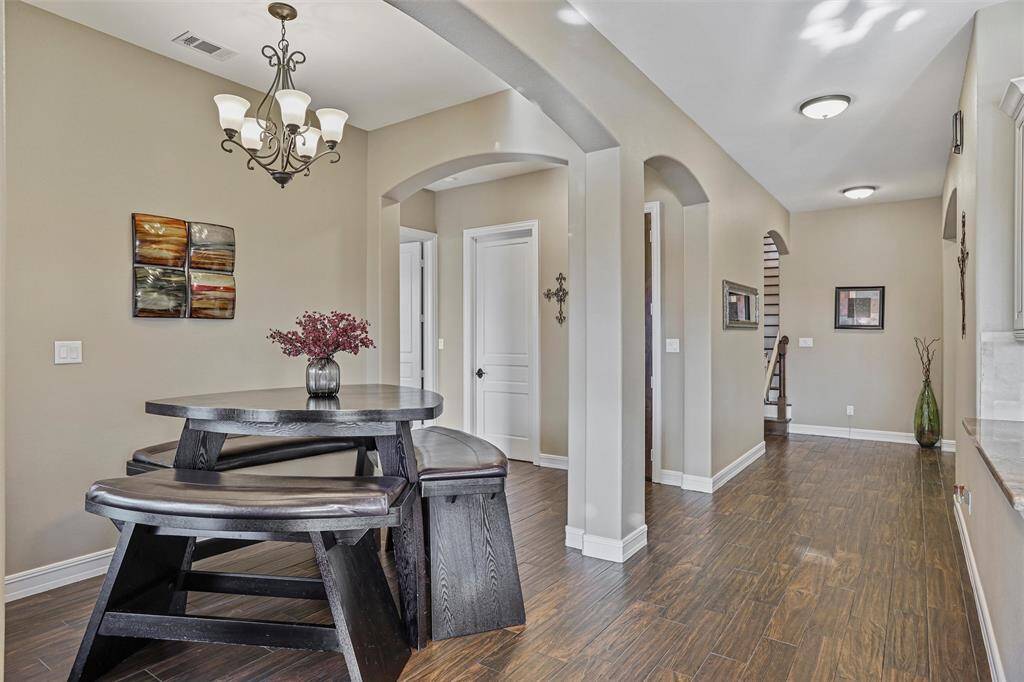 The breakfast room, conveniently adjacent to the kitchen, offers effortless serving and a cozy dining experience.
