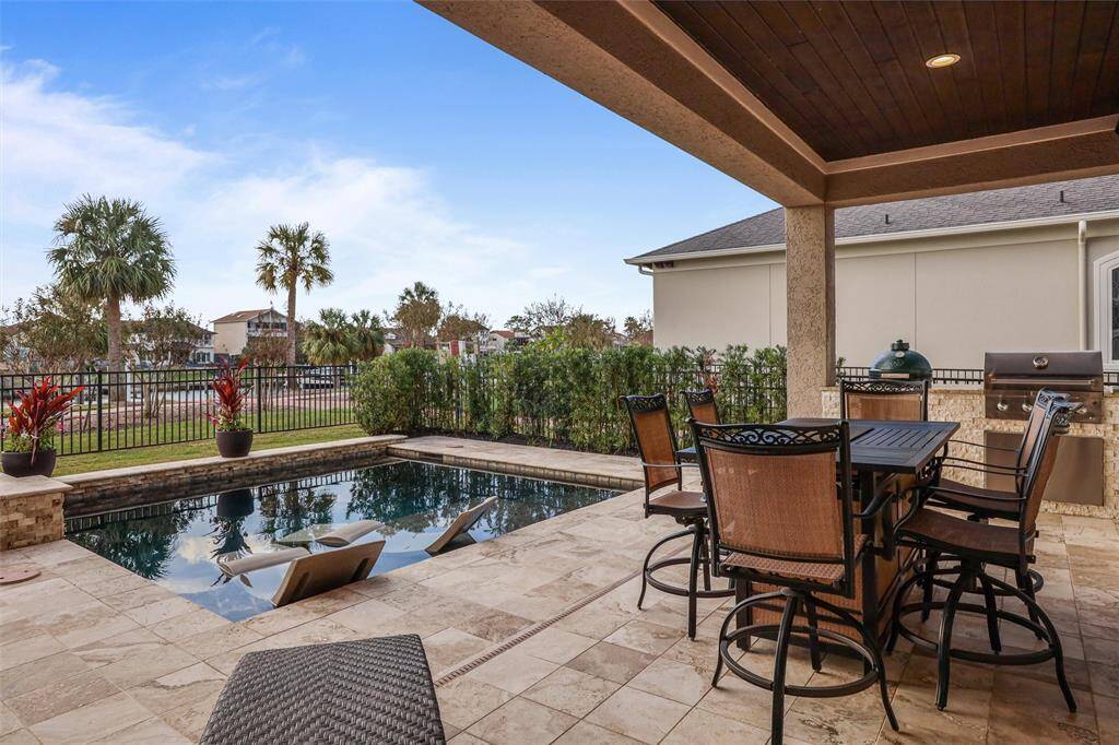 Enjoy ultimate relaxation in this refreshing pool with in-water lounge chairs, perfect for staying cool.