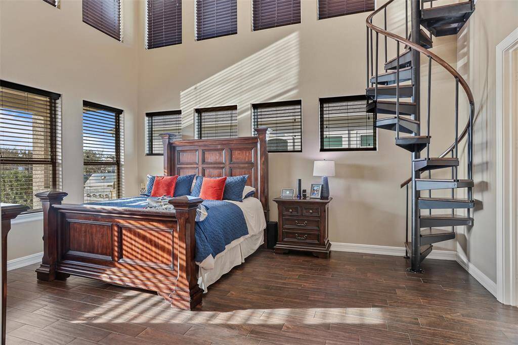 The spacious Primary Suite easily fits large furnishings and offers convenient access to the upstairs office.