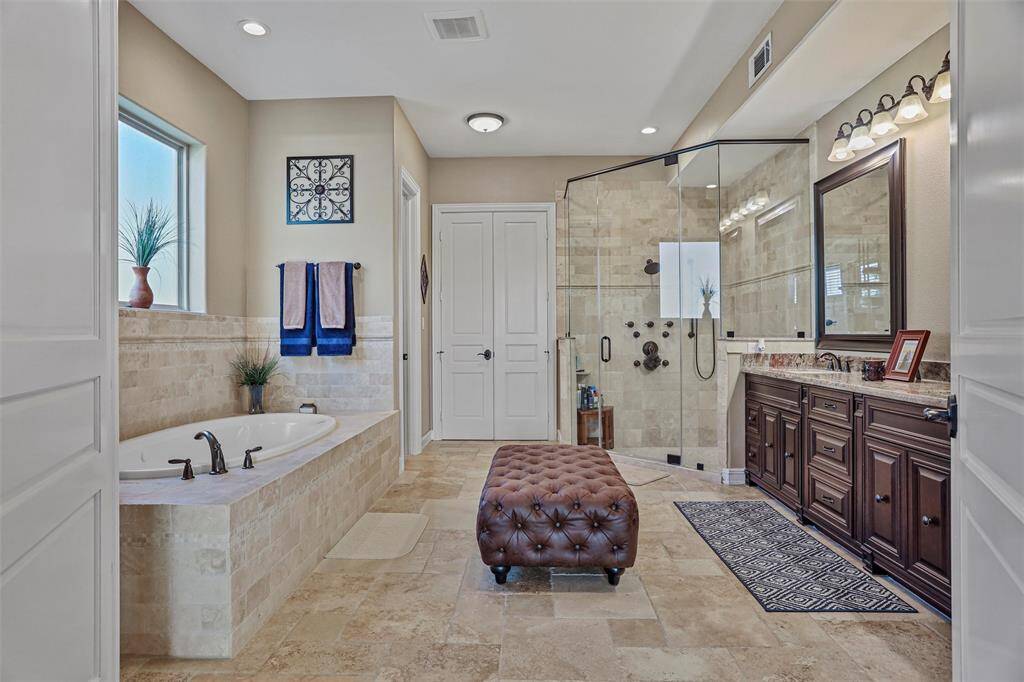Indulge in the luxurious soaking tub or unwind in the expansive shower.