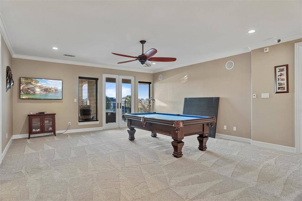 Upstairs, discover a spacious game room perfect for entertainment and relaxation.